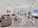 Bright, spacious living room with tile floors, ceiling fan, and comfortable seating creating an inviting area at 608 Fair Winds Dr # 608, Nokomis, FL 34275