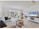 Bright living room with water view, comfortable seating, and stylish furnishings offer a relaxing atmosphere at 608 Fair Winds Dr # 608, Nokomis, FL 34275