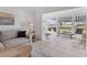 Inviting living room featuring large windows with blue-striped awning and waterfront view at 608 Fair Winds Dr # 608, Nokomis, FL 34275