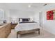 A stylish main bedroom with ensuite bathroom, ceiling fan, and colorful art at 608 Fair Winds Dr # 608, Nokomis, FL 34275