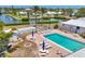 Aerial view of pool and patio area with lounge chairs and outdoor seating at this community at 608 Fair Winds Dr # 608, Nokomis, FL 34275