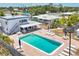 Aerial view of a private in-ground pool, patio and outdoor seating at this well maintained home at 608 Fair Winds Dr # 608, Nokomis, FL 34275