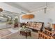 Beautiful sun room with bright light, comfortable seating, and glass table with wicker accents at 608 Fair Winds Dr # 608, Nokomis, FL 34275