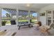 Bright sunroom with tile floors, canal views, and comfortable seating at 608 Fair Winds Dr # 608, Nokomis, FL 34275