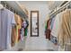 Walk-in closet featuring organized shelving, rods, and a full-length mirror at 608 Fair Winds Dr # 608, Nokomis, FL 34275