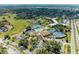 A drone view of residences with amenities including a pool, tennis courts, and clubhouse at 618 Bird Bay S Dr # 110, Venice, FL 34285