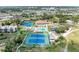 Overhead shot of community amenities, including tennis courts and a sparkling pool, surrounded by residences at 618 Bird Bay S Dr # 110, Venice, FL 34285