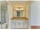 Bathroom vanity with granite counters, white cabinets, and shower/toilet alcove at 618 Bird Bay S Dr # 110, Venice, FL 34285