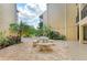 Scenic courtyard with a stone table and benches, perfect for relaxing and enjoying the outdoors at 618 Bird Bay S Dr # 110, Venice, FL 34285