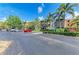 Condo building with parking lot, landscaping and palm trees at 618 Bird Bay S Dr # 110, Venice, FL 34285