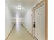 Hallway leading to unit with well-lit hallway at 618 Bird Bay S Dr # 110, Venice, FL 34285