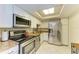 Bright kitchen with stainless appliances, granite counters, and white cabinetry at 618 Bird Bay S Dr # 110, Venice, FL 34285