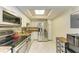 Well-lit kitchen featuring stainless steel appliances, granite countertops, and ample cabinet space at 618 Bird Bay S Dr # 110, Venice, FL 34285