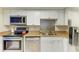 Close-up view of kitchen area with stainless appliances and decorative backsplash at 618 Bird Bay S Dr # 110, Venice, FL 34285