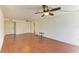 Open-concept living area with hardwood floors and ceiling fan at 618 Bird Bay S Dr # 110, Venice, FL 34285