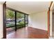 Bright living room featuring floor-to-ceiling windows that overlook the landscaped exterior at 618 Bird Bay S Dr # 110, Venice, FL 34285