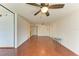 Bright living room with hardwood floors, a ceiling fan, and a glass table at 618 Bird Bay S Dr # 110, Venice, FL 34285