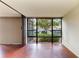 Living area with expansive sliding window, hardwood floors, and natural light at 618 Bird Bay S Dr # 110, Venice, FL 34285