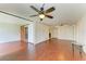 Living room with hardwood floors, a view to bathroom, and closet space at 618 Bird Bay S Dr # 110, Venice, FL 34285
