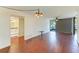 Spacious living room with hardwood floors, neutral paint, and sliding door to balcony at 618 Bird Bay S Dr # 110, Venice, FL 34285