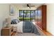 Cozy main bedroom with a large window view, ceiling fan, wood floors and closet at 618 Bird Bay S Dr # 110, Venice, FL 34285