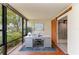 Bright office with a large window view, light-colored walls, and a barn door access to bathroom at 618 Bird Bay S Dr # 110, Venice, FL 34285