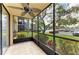Relaxing screened patio with tiled floor and views of the green landscape at 618 Bird Bay S Dr # 110, Venice, FL 34285