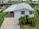 Aerial view of a well-maintained home with lush landscaping and canal access at 700 Blackburn Blvd, North Port, FL 34287