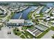 Expansive aerial view showcases waterfront community with a marina, swimming pool, and shuffleboard courts at 700 Blackburn Blvd, North Port, FL 34287