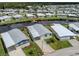 Aerial view of a home with canal access and a dock in a vibrant community at 700 Blackburn Blvd, North Port, FL 34287