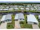 Aerial view showcasing a waterfront home with canal access in a community setting at 700 Blackburn Blvd, North Port, FL 34287