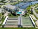 Community aerial view with a pool, shuffleboard courts, a marina, and surrounding green spaces and houses at 700 Blackburn Blvd, North Port, FL 34287