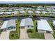 Aerial view showcasing a waterfront home with canal access in a community setting at 700 Blackburn Blvd, North Port, FL 34287
