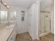 Bright bathroom featuring a shower, vanity, and ample storage with a storage cabinet at 700 Blackburn Blvd, North Port, FL 34287