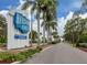 Entrance to Harbor Cove waterfront community, lush landscaping and swaying palm trees at 700 Blackburn Blvd, North Port, FL 34287