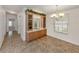 Dining area with tile flooring, custom cabinetry, and a decorative chandelier at 700 Blackburn Blvd, North Port, FL 34287