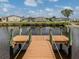 Private wooden dock with canal access in a waterfront community, perfect for boating and outdoor activities at 700 Blackburn Blvd, North Port, FL 34287