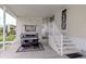 White home exterior with golf cart under covered parking and decorative front door with tiled steps at 700 Blackburn Blvd, North Port, FL 34287