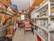 Functional garage space with shelving and work area, ideal for storage and projects at 700 Blackburn Blvd, North Port, FL 34287
