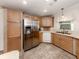 Well lit kitchen featuring stainless steel refrigerator and plentiful cabinet space for storage at 700 Blackburn Blvd, North Port, FL 34287