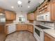 Well-equipped kitchen featuring updated appliances, tile floors, and ample counter space at 700 Blackburn Blvd, North Port, FL 34287