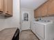 Well-equipped laundry room with washer, dryer, and extra cabinets for convenient storage at 700 Blackburn Blvd, North Port, FL 34287