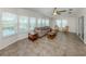 Sunlit living room featuring tile flooring, comfortable seating, and ample natural light at 700 Blackburn Blvd, North Port, FL 34287
