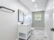 Bathroom with a white vanity, black fixtures, and a window for natural light at 7140 Teaberry St, Englewood, FL 34224