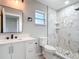Updated bathroom with a marble-tiled shower, sleek black hardware, and modern vanity at 7140 Teaberry St, Englewood, FL 34224
