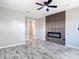Bedroom with modern fireplace wall, ceiling fan and wood-look tile flooring at 7140 Teaberry St, Englewood, FL 34224