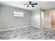 Bedroom with wood-look tile flooring and access to bathroom and closet at 7140 Teaberry St, Englewood, FL 34224