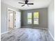 Bedroom features wood-look tile flooring, a ceiling fan and natural light at 7140 Teaberry St, Englewood, FL 34224