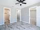 This bedroom features wood-look tile flooring and access to the bathroom and closet at 7140 Teaberry St, Englewood, FL 34224