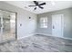 Bedroom with neutral paint, modern ceiling fan, and access to en-suite bathroom at 7140 Teaberry St, Englewood, FL 34224